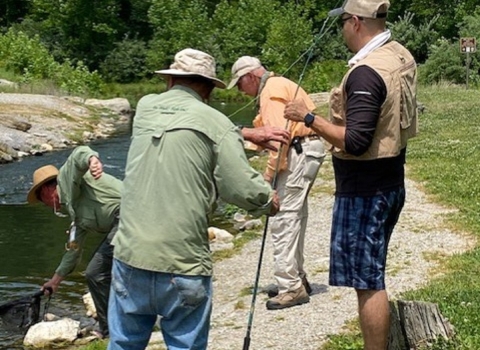 A group of men fly fishing