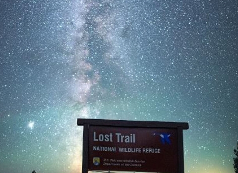 The Milky Way alights the entrance sign to Lost Trail National Wildlife Refuge 