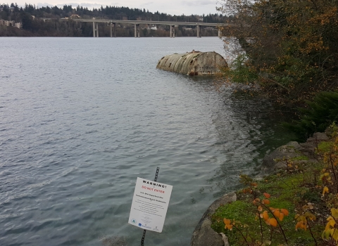 Shoreline with a posted warning sign reading "do not enter"