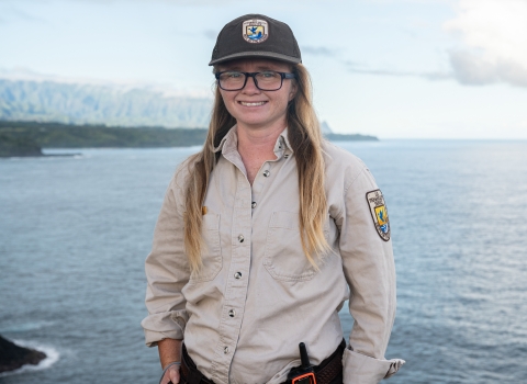 Laurel Smith, smiling in uniform, at Kīlauea Point National Wildlife Refuge in Hawaii. Photo Credit: Angela Iwai-Pineda 