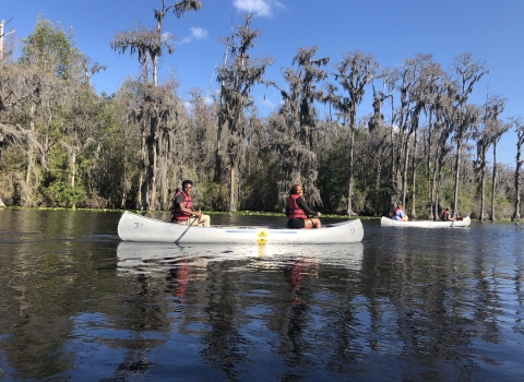 Students paddle a canoe downriver at the Okefenokee National Wildlife Refuge.