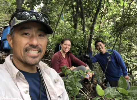 James Kwon in the forest with two other people