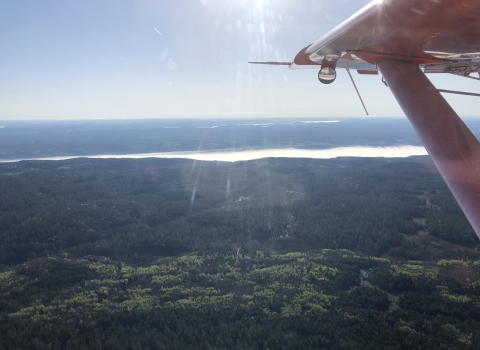 view of an airplane wing over the landscape