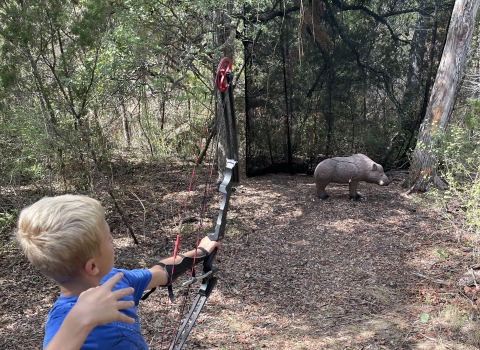 5th grade student shooting a boar at the 3D archery course at Inks Dam NFH.