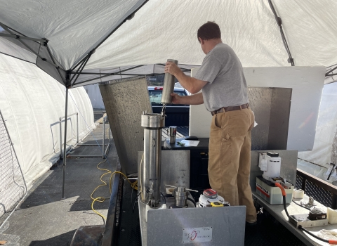 Staff from the NC Wildlife Resources Commission placing trout eggs into a pressurization chamber.