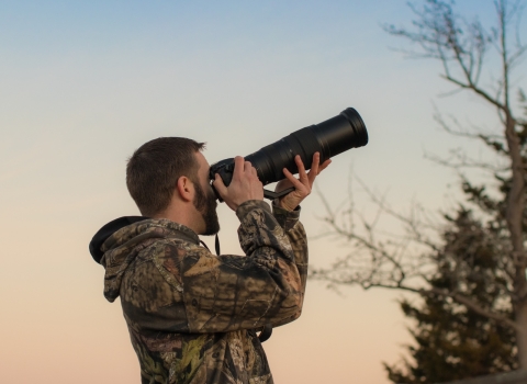 Man taking pictures of wildlife as the sun goes down in Western Maryland. 