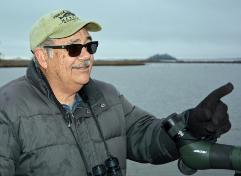 Photo of birding guide Terry Allen with his scope next to the Blackwater River.