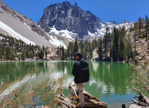 Armando at Big Pines Lake featuring a lake and snow capped mountains