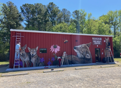 a large red building with animals on it