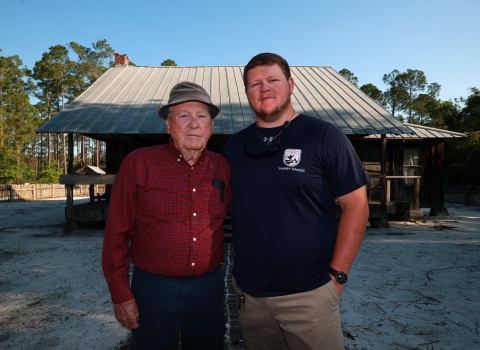 Left, Joe Lester Chesser and his grandson Andrew stand in front of the old Homestead site that is now part of the Okefenokee National Wildlife Refuge. Joe, 89, grew up there and left when the refuge took over in 1971. Today Andrew works for the American Conservation Experience taking care of 120 canoe trails in the refuge. 