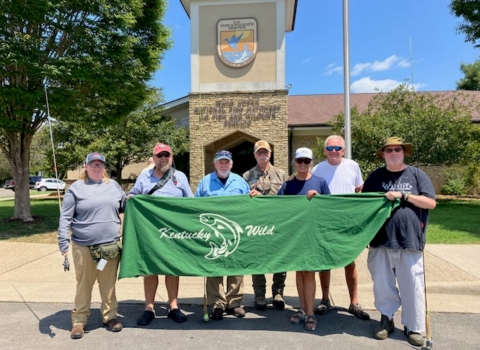 Group photo holding Kentucky Wild banner