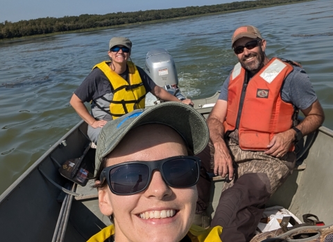 three people in a boat