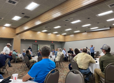 People sitting at tables in conference area