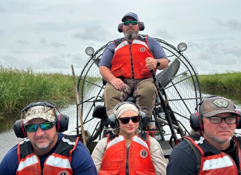 four people in an airboat