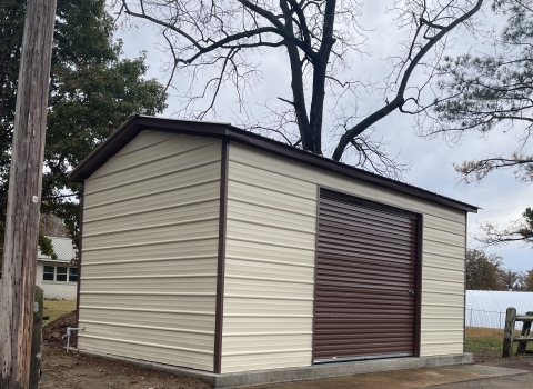 A brown building with a darker brown garage door