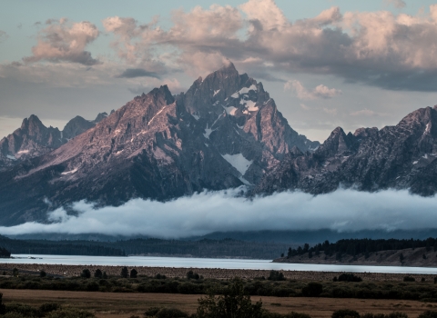 Clouds surround the major peaks of the Teton Range over Jackson Lake and Willow Flats.