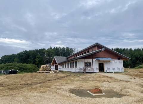 half constructed building sits on land in the middle of construction site
