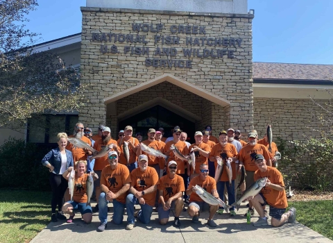 Group of people holding fish