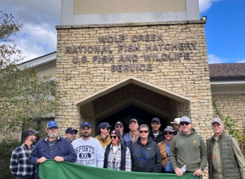 Group posing with banner