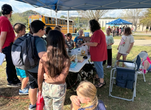 Kids learning at info booth